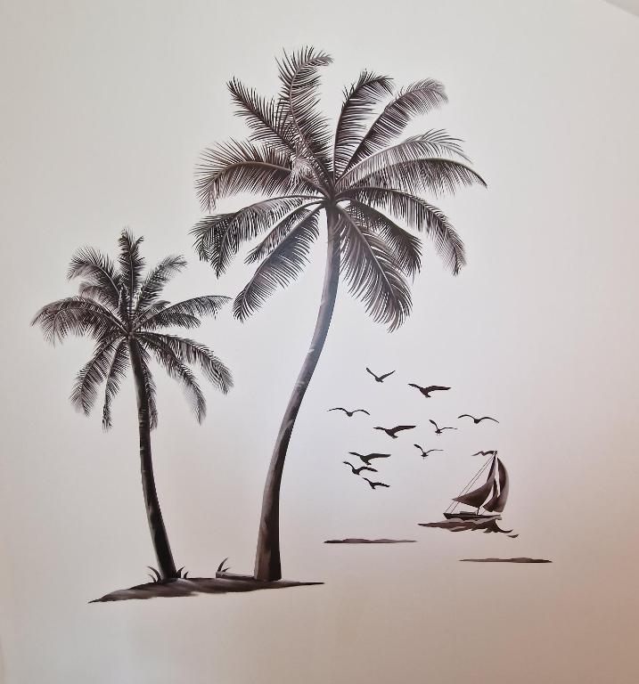 two palm trees and a boat on the beach with a flock of birds at AVD - Residence Palma in Udine
