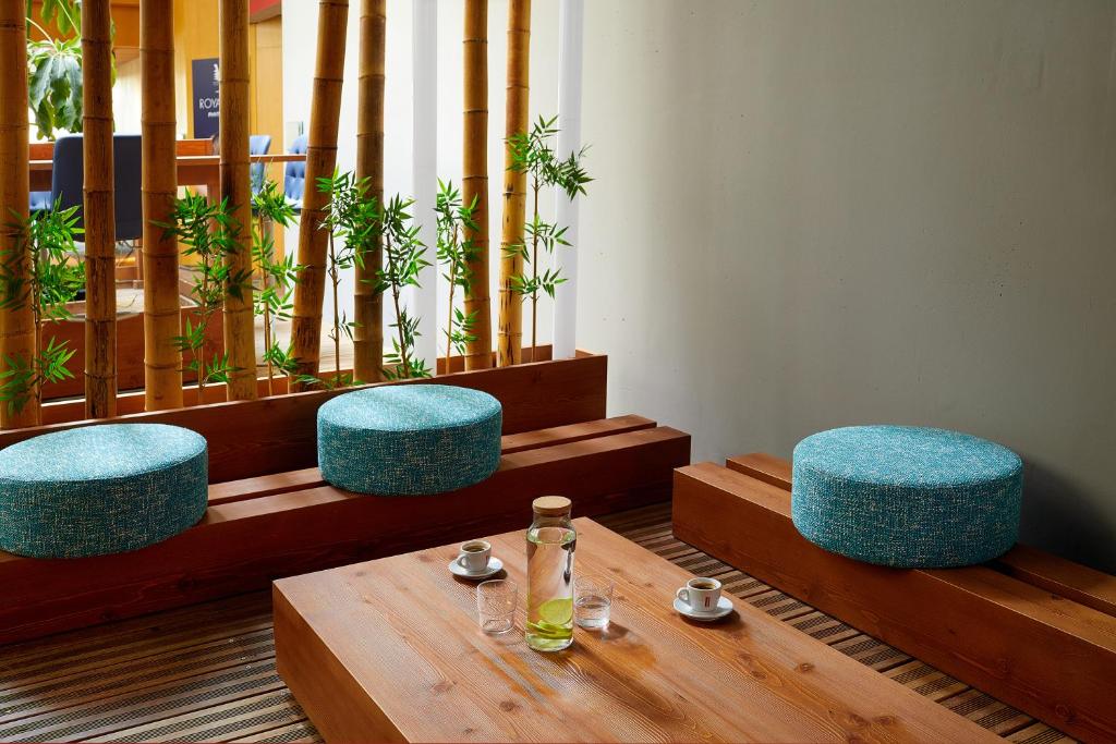 a table with two blue chairs and a bottle on it at Royal Antibes - Luxury Hotel, Résidence, Beach & Spa in Antibes