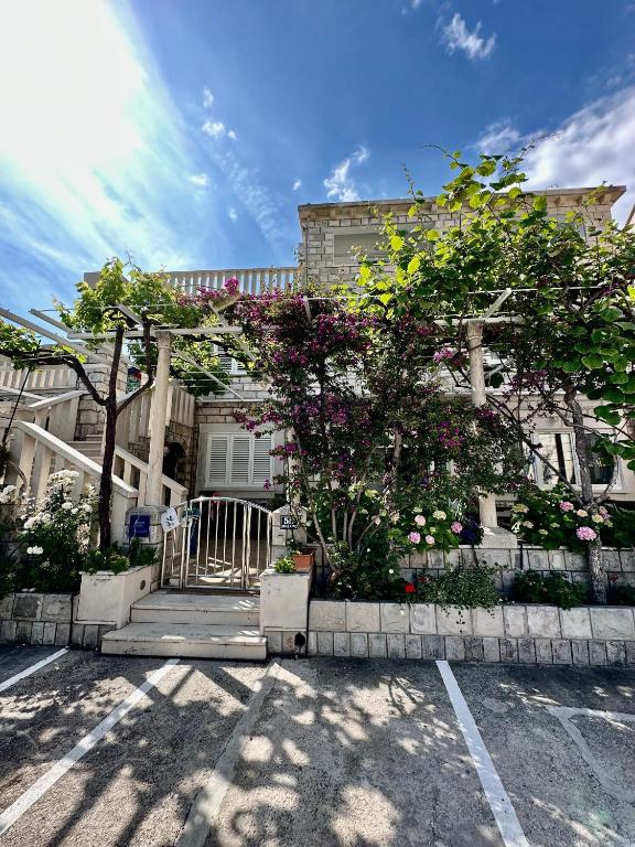 a house with a tree in a parking lot at Villa Mare & Filip 2 in Zaton