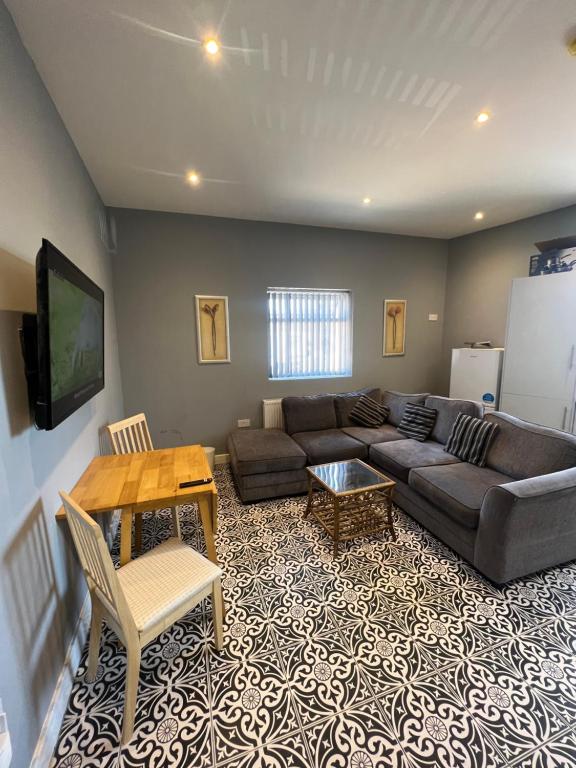 a living room with a couch and a table at City West Apartments 3 bedroom large & modern Apartment in Newcastle upon Tyne