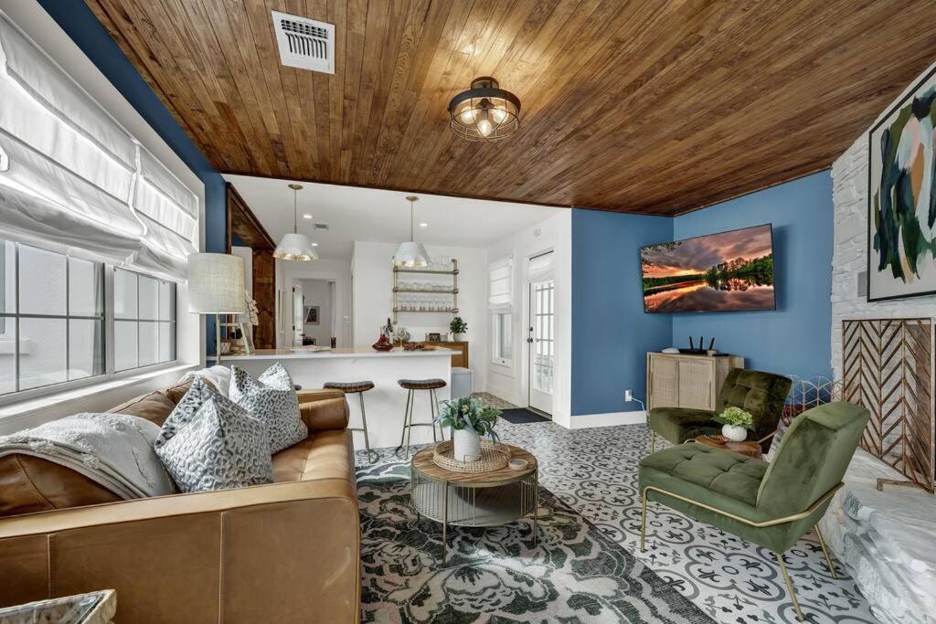 a living room with a couch and a table at Wine Down House - Fire Pit & Walk to Main St in Fredericksburg