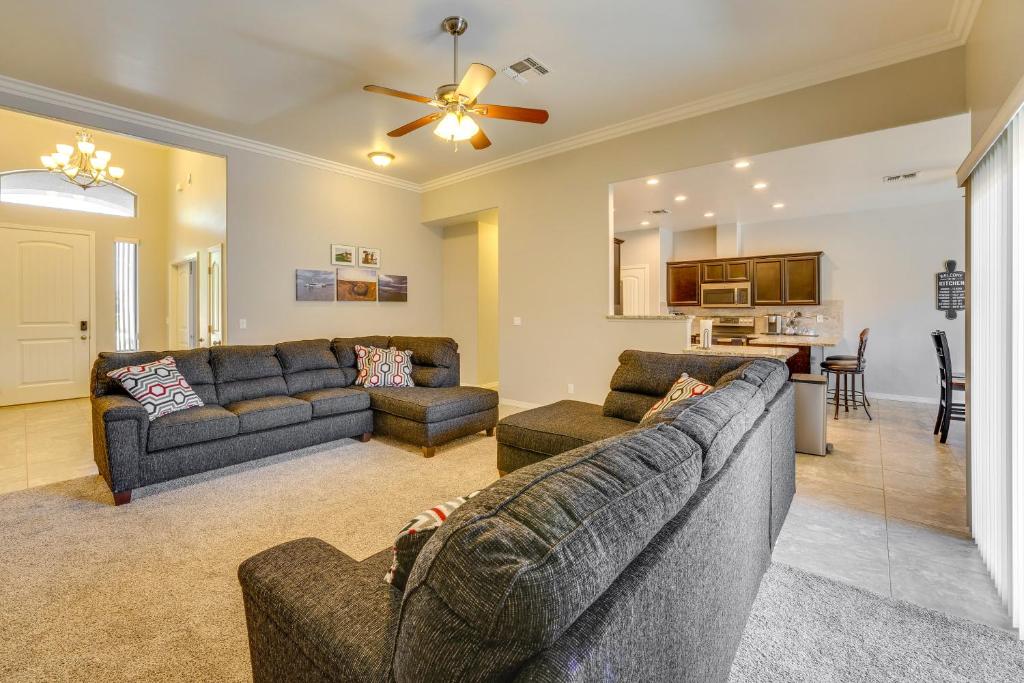 a living room with two couches and a kitchen at Beautiful Bullhead City Home Rental with Yard! in Bullhead City