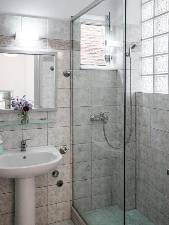 a bathroom with a sink and a shower at Himara Hostel in Himare