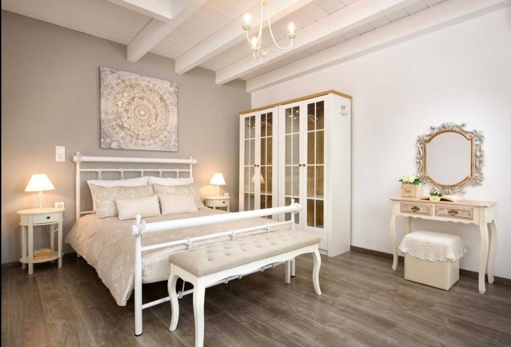 a bedroom with a white bed and a mirror at The Gastouri House, Located In Central Corfu, Near Benitses in Gastouri