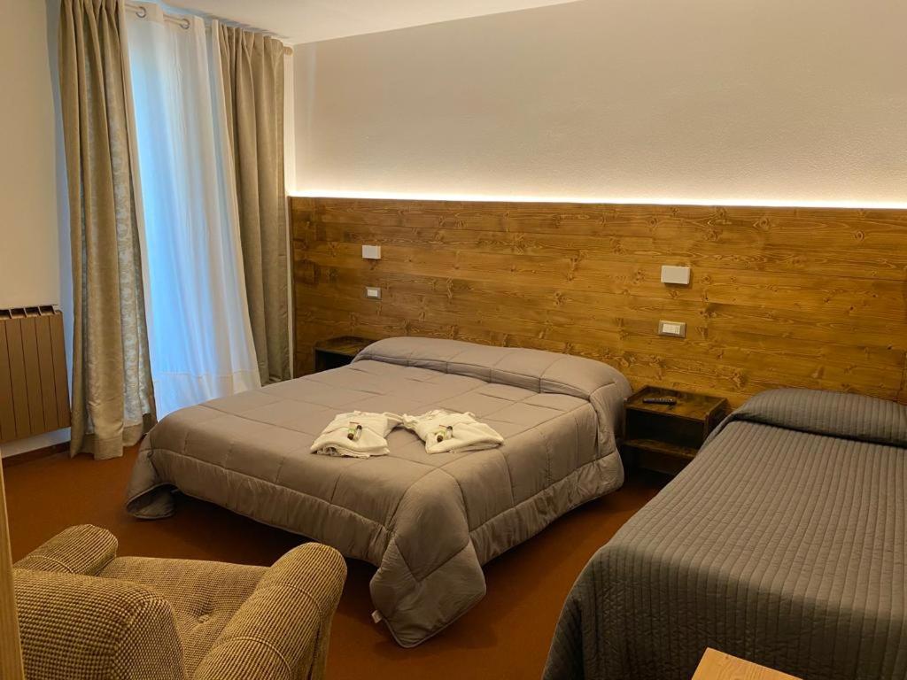 Postel nebo postele na pokoji v ubytování Albergo Quai