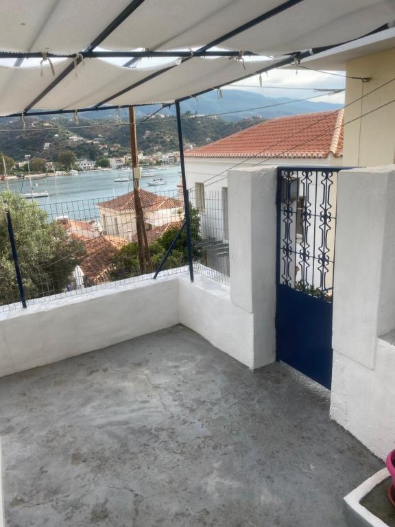 a balcony of a house with a view of the water at Aggeliki Homes paradosiako nisiotiko in Poros
