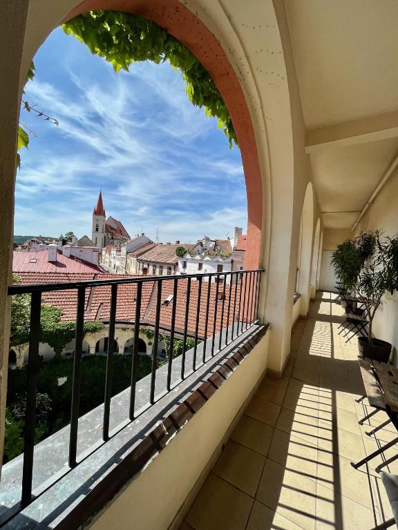 a balcony with a view of a city at Palác Daun - Studio Apartments in Znojmo