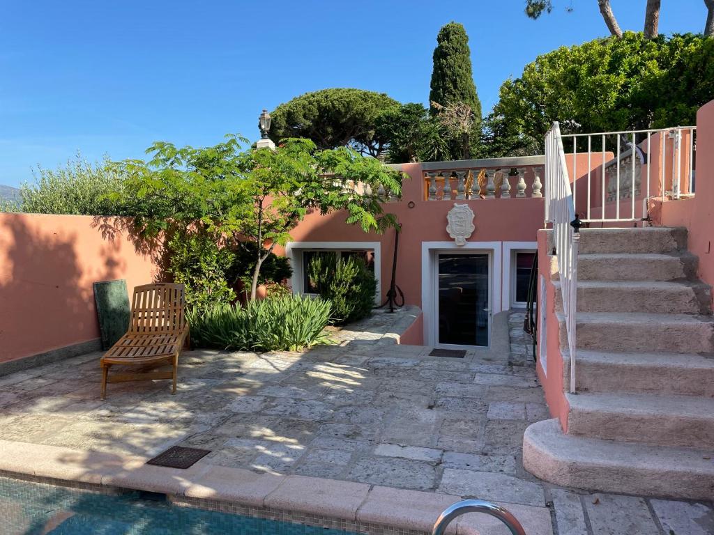 a house with a staircase next to a swimming pool at Chambre d'hôtes A l'ancre marine in Nice