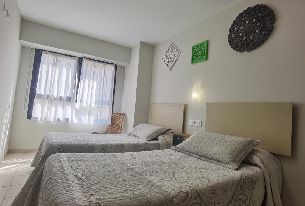 Postel nebo postele na pokoji v ubytování HOSTAL RIGAU