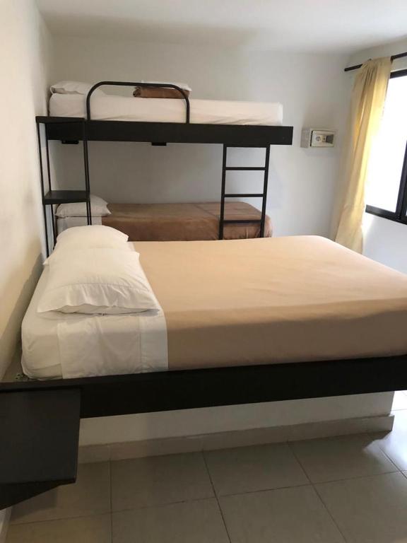 Postel nebo postele na pokoji v ubytování Casa Kiwi Hostel
