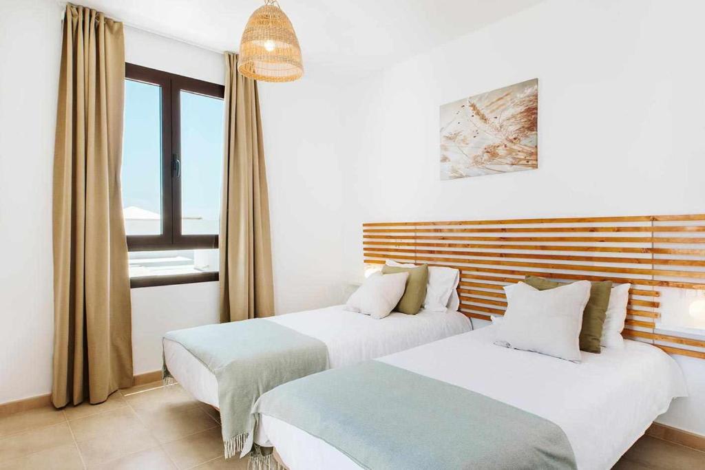 Postel nebo postele na pokoji v ubytování Villa Lyra Piscina Climatizada