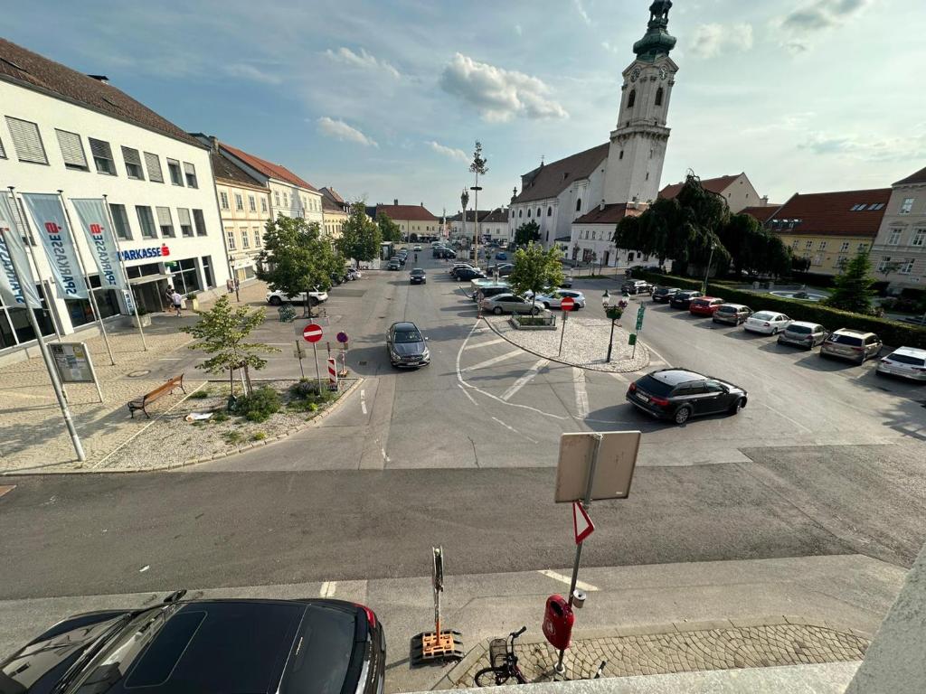 une rue de la ville avec des voitures garées dans un parking dans l'établissement Central Plaza family apartment 2 bedroom, à Bruckneudorf