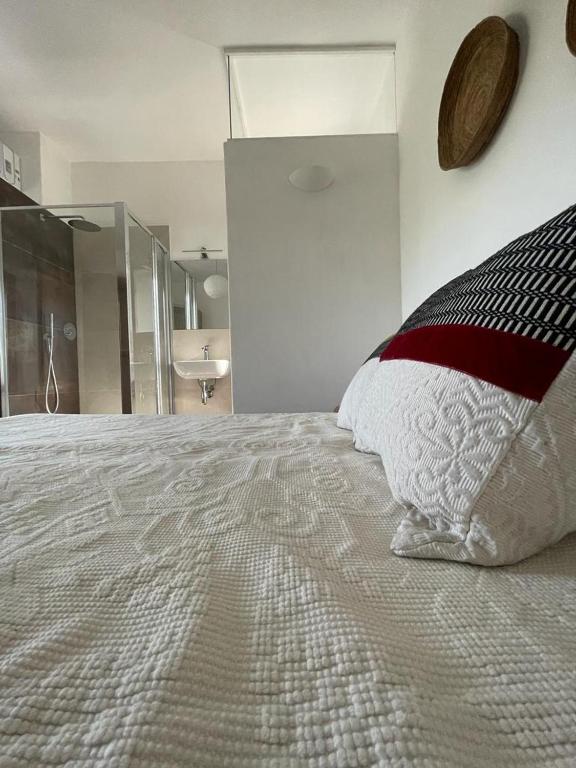 a bedroom with a large bed with a pillow on it at Kepos room in Tortolì