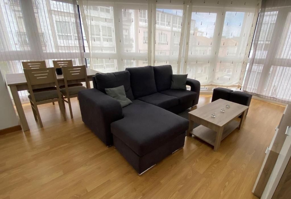 a living room with a couch and a table at A Segunda Ronda in Melide