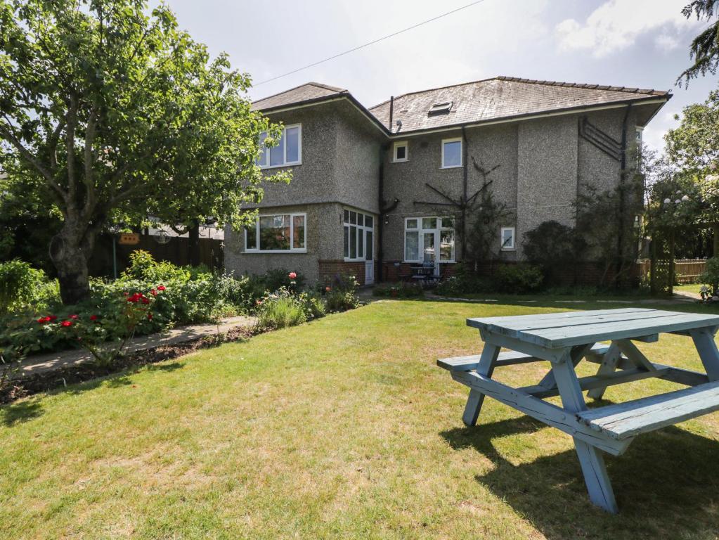 a picnic table in front of a house at Molly's Place in Bournemouth