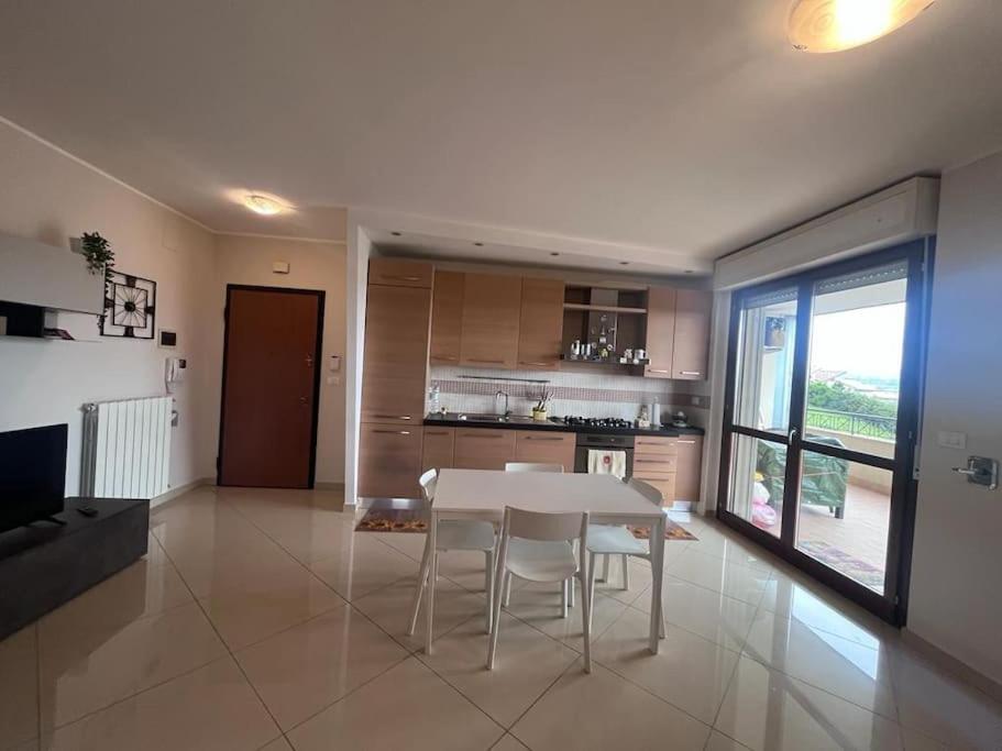 een keuken en eetkamer met een witte tafel en stoelen bij Vacanze vista mare in Montesilvano