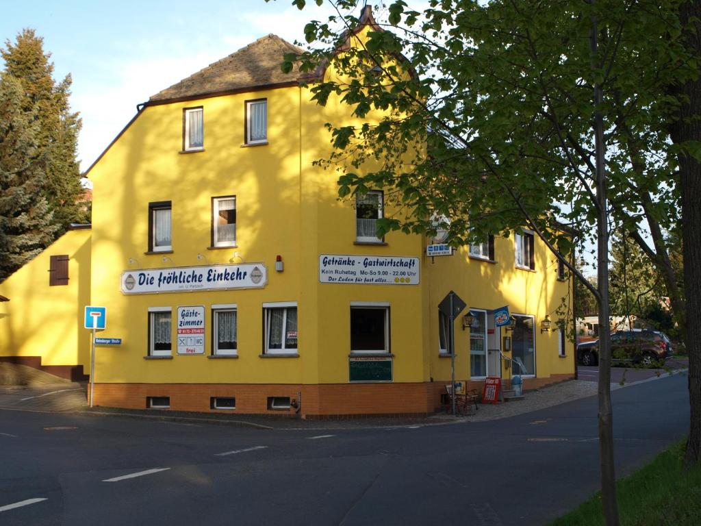 a yellow building on the side of a street at Pension Partzsch in Siebenlehn