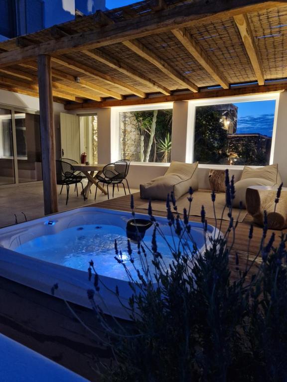 a jacuzzi tub in the middle of a patio at Levantes House Mykonos in Ano Mera