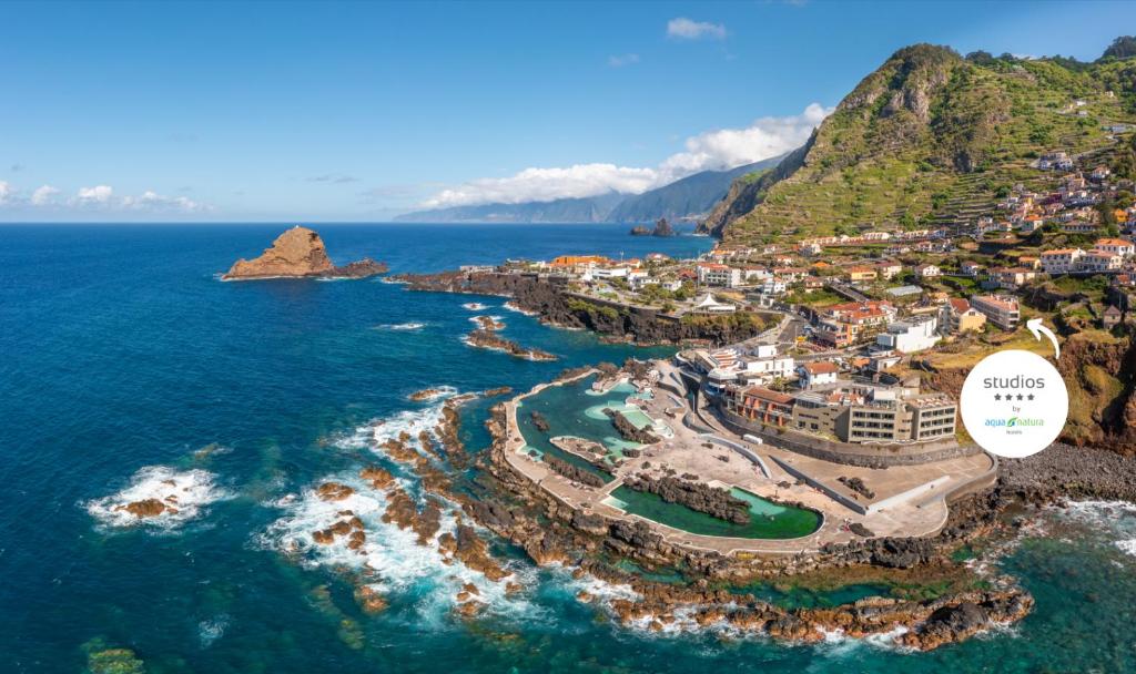 an aerial view of a resort on the coast at Studios by Aqua Natura Hotels in Porto Moniz