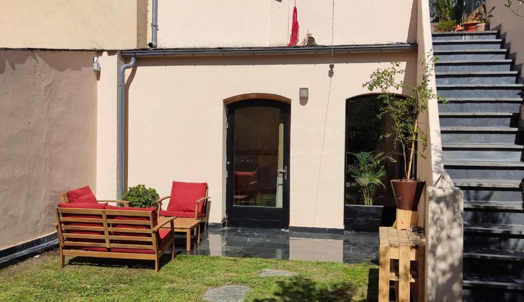 a patio with two chairs and a door and stairs at HOSTEL NAMOR in Ribadeo