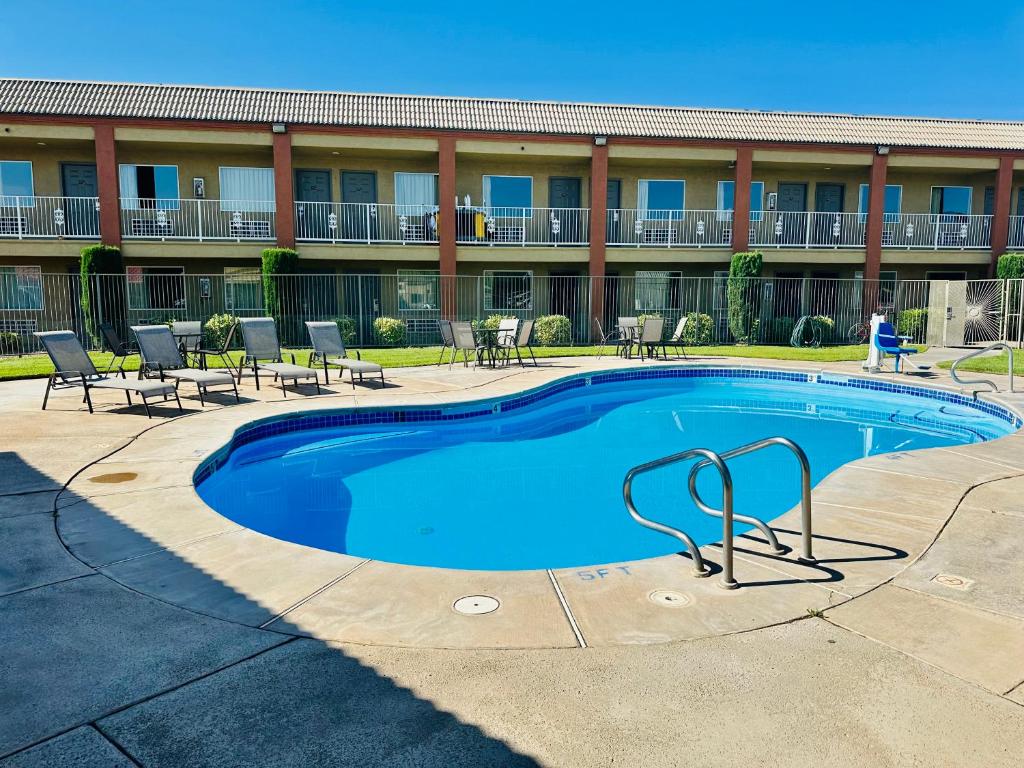 a swimming pool in front of a hotel at Super 8 by Wyndham Hurricane Zion National Park in Hurricane