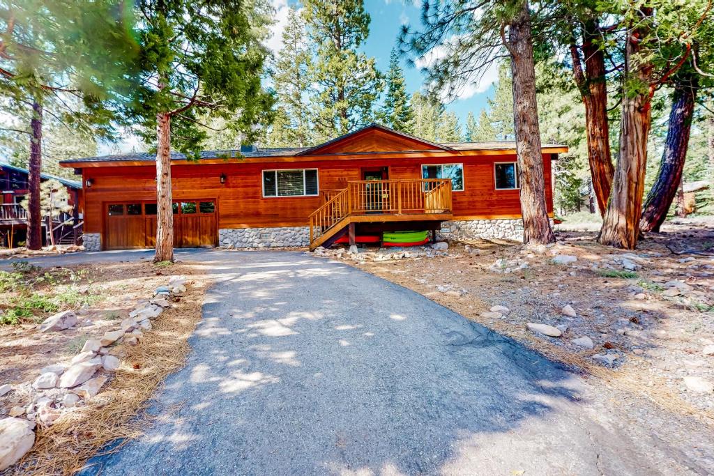 a log home with a porch and a driveway at Relax on Pretoria in Carnelian Bay