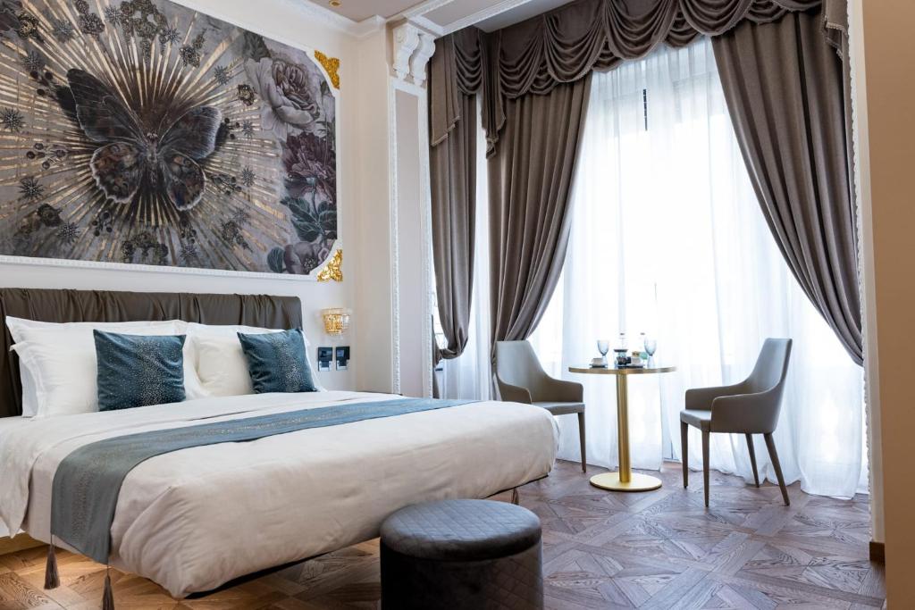 a bedroom with a large bed and a large window at Queen Cattleya Suite in Genova