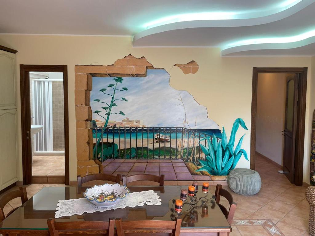 a living room with a painting on the wall at Don Concetto in Marzamemi