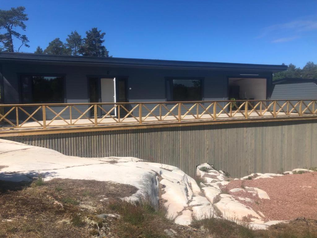 a house with a balcony on the side of it at Kemping 1 in Föglö