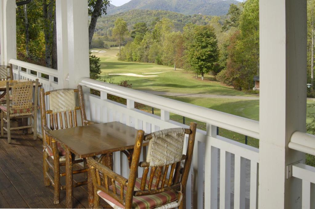 a porch with a table and chairs and a view at Brasstown Valley Resort & Spa in Young Harris