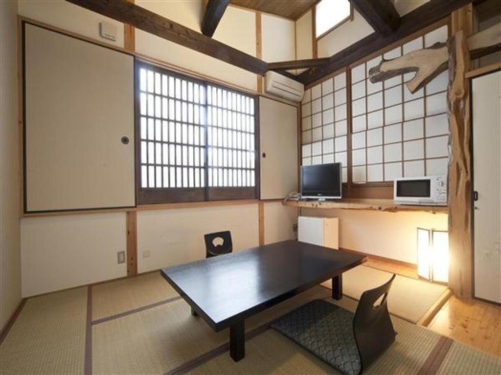 a large room with a table and a tv at Kannawa Onsen Zekkei no Yado Sakuratei - Vacation STAY 50714v in Beppu