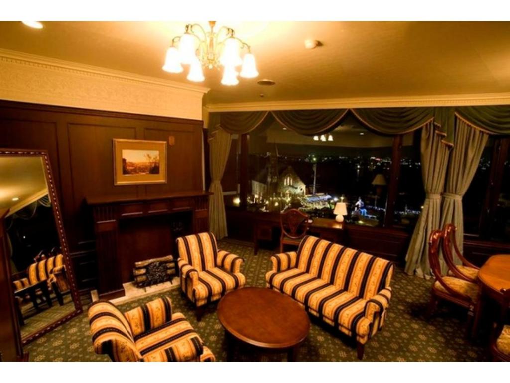 a living room with chairs and a table and a bar at Hotel Sunlife Garden - Vacation STAY 55411v in Hiratsuka