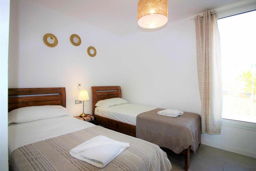 Postel nebo postele na pokoji v ubytování Monterey House Playa Blanca