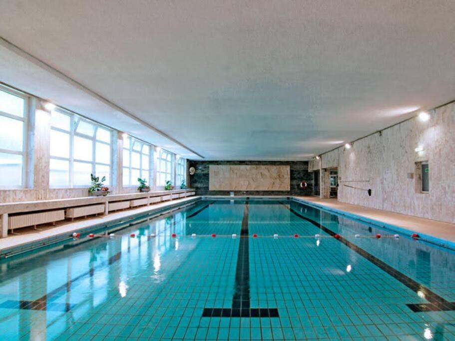 an indoor swimming pool with a large pool at Dora, impressionistischen Stil in Bergheim