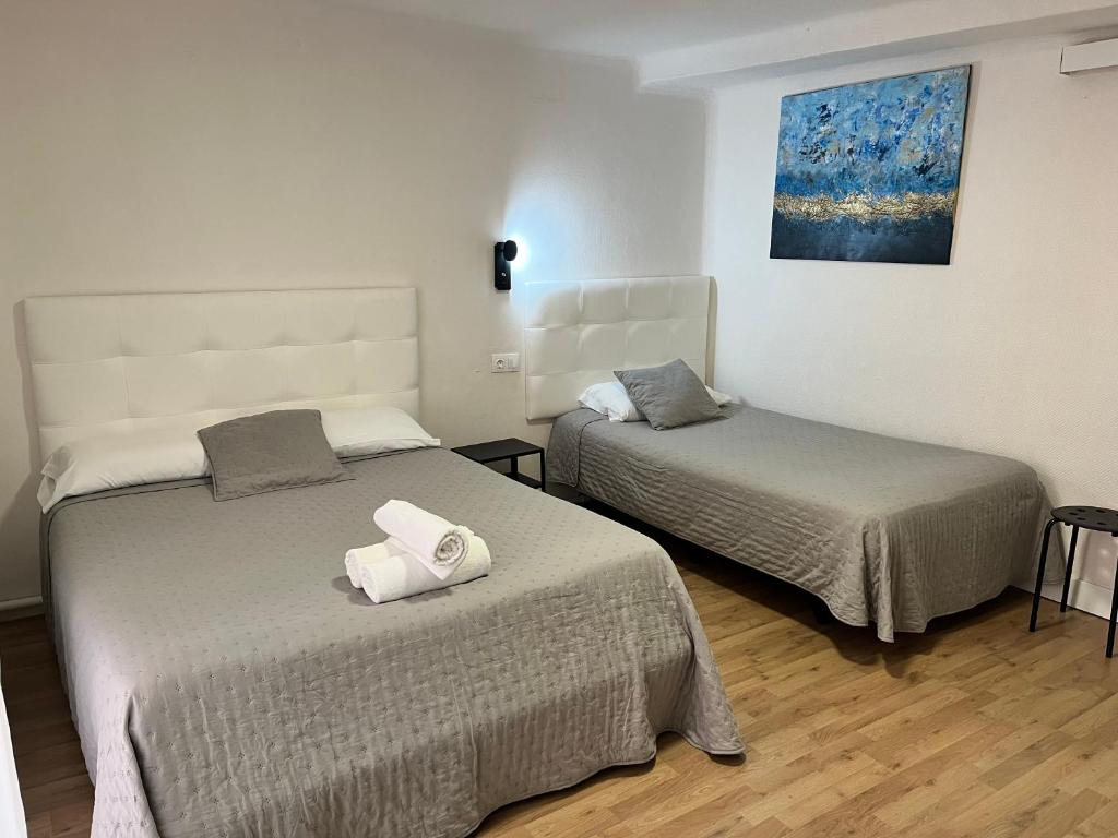 Posteľ alebo postele v izbe v ubytovaní Hostal ARS