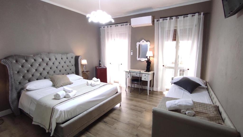 a bedroom with two beds and a chair in it at claire de lune in Cagliari