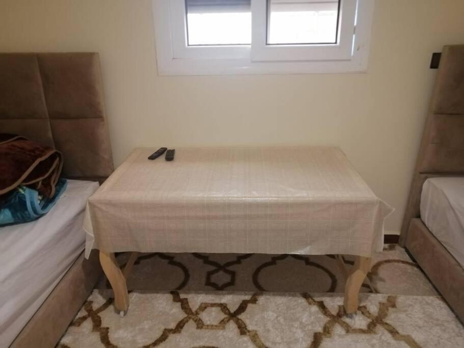 - une table dans une chambre avec un lit et une fenêtre dans l'établissement Modern flat Dakhla, à Dakhla