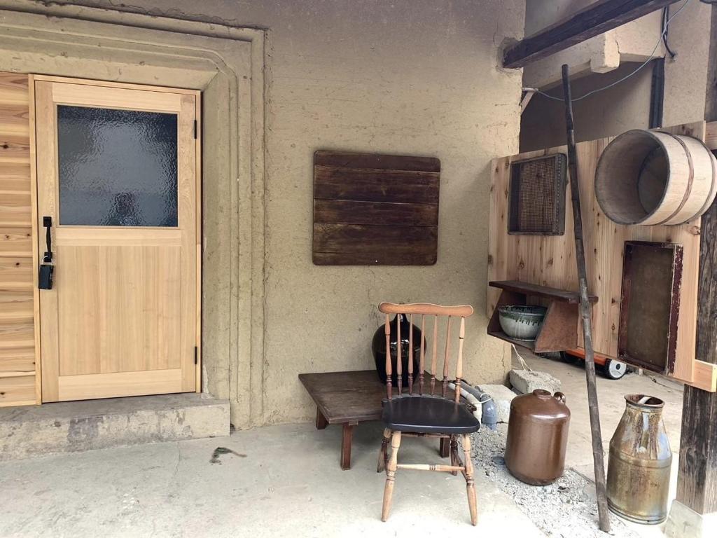 a room with a wooden chair and a door at Nagano - House - Vacation STAY 14689 in Nagano