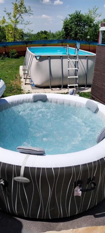 a large hot tub in a yard with two swimming pools at Dalbo House 