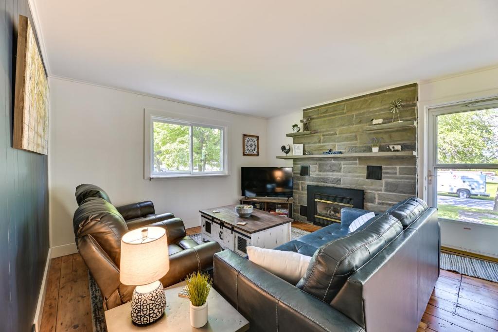 a living room with leather furniture and a fireplace at Pet-Friendly Upstate NY Home Less Than 1 Mi to Cayuga Lake in Aurora