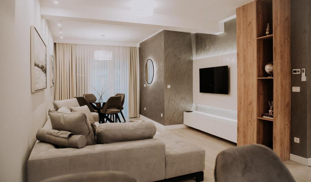 a living room with a couch and a tv at Apartman Pelagić in Brčko