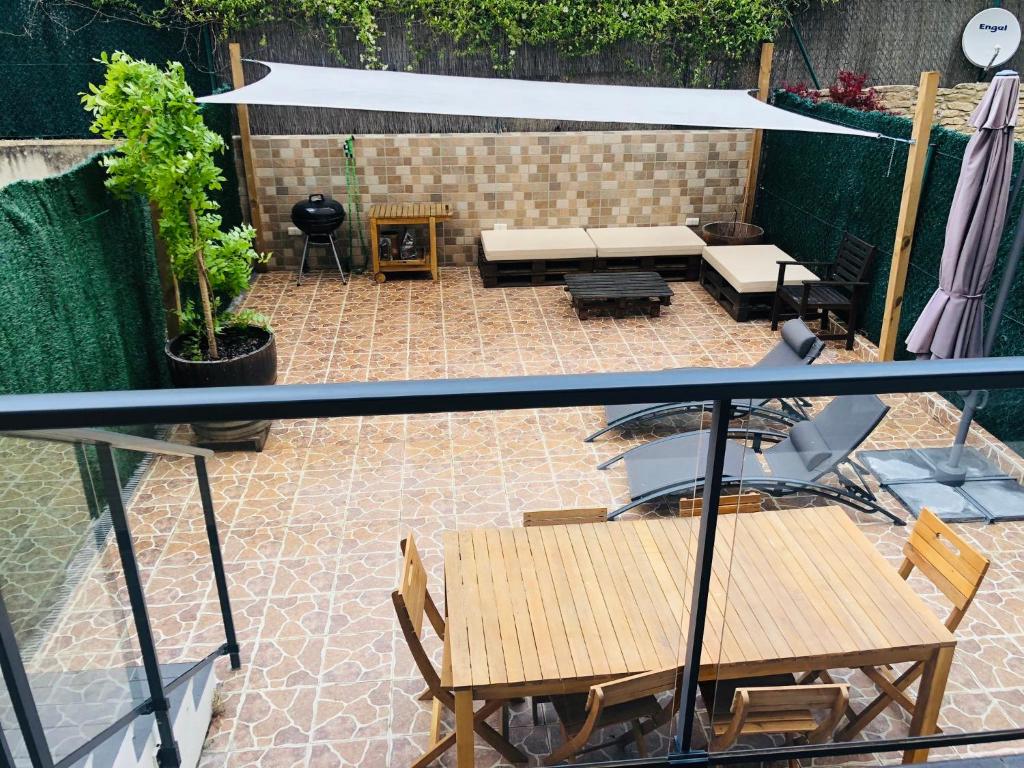 un patio con mesas y sillas y un dosel blanco en La Puerta de Viana, con desayuno, piscina y posibilidad Visita a bodega!, en Viana