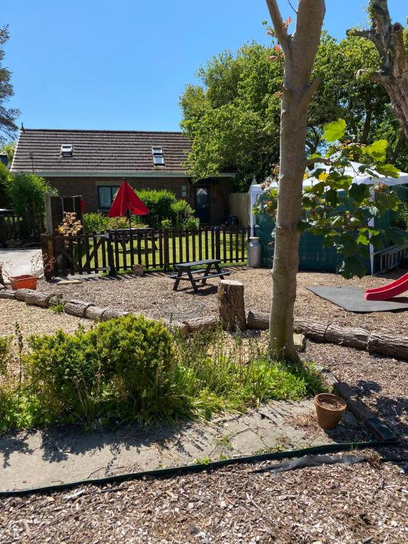 a backyard with a picnic table and a tree at Green Little Acre in Little Singleton