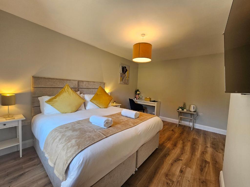 a bedroom with a large bed with yellow pillows at The Cé Hideout in Tralee