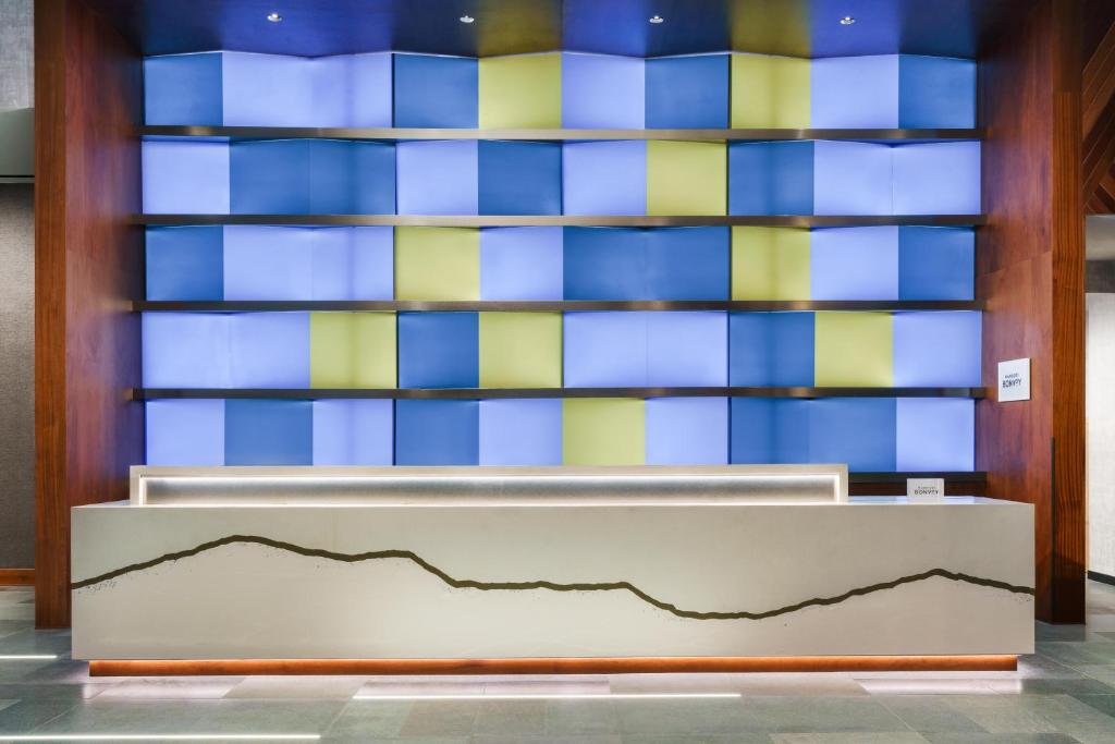 a lobby with a wall with blue and yellow tiles at Courtyard New York Downtown Manhattan/Financial District in New York