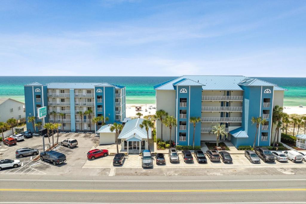 an aerial view of a hotel with a parking lot at Sugar Sands Beachfront Hotel, a By The Sea Resort in Panama City Beach