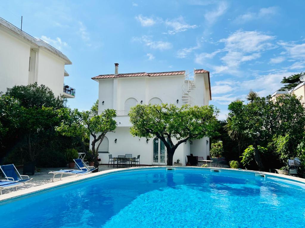 a swimming pool in front of a house at YourHome - Villa Sorrento in Meta