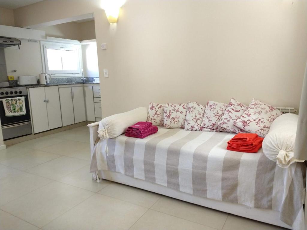 a living room with a couch with pillows on it at Departamento Ramayon in San Martín de los Andes