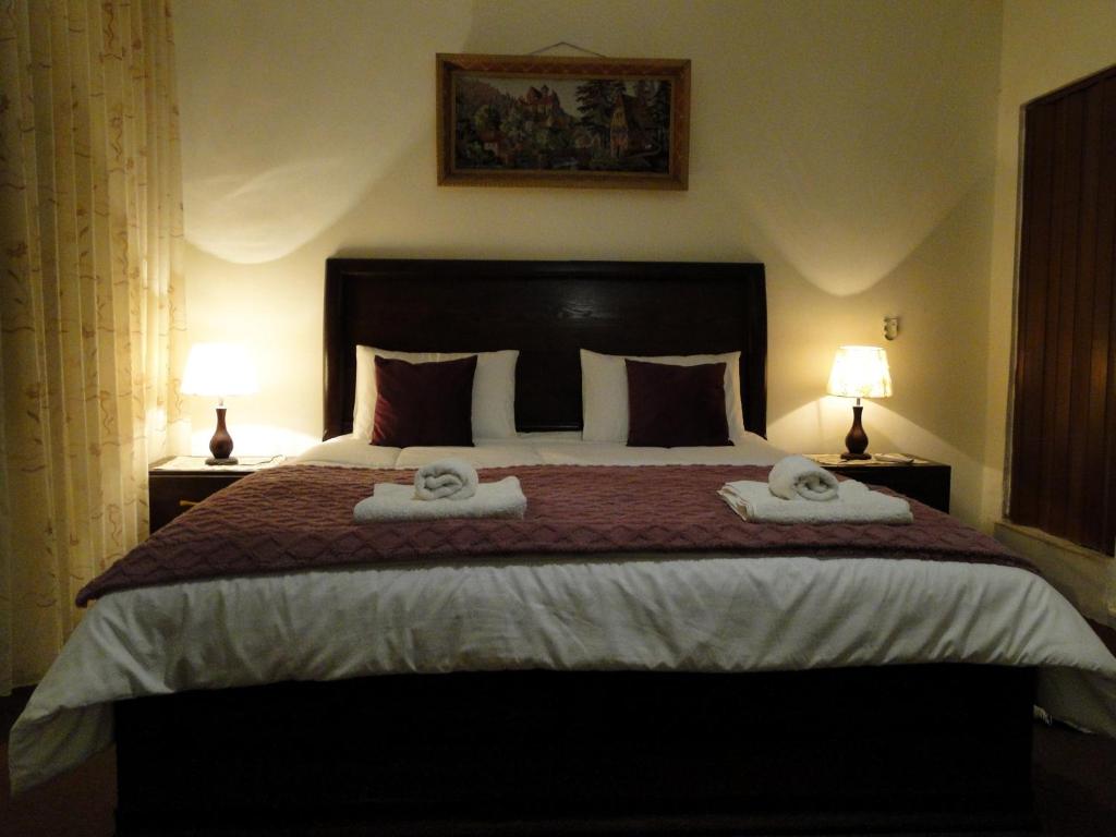 a bedroom with a large bed with two towels on it at ( b&b ) Gadara rent room in Um Qeis
