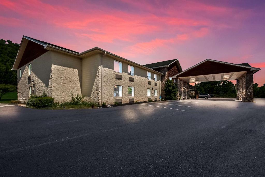 a rendering of a building with a sunset at SureStay Plus Hotel by Best Western Berkeley Springs in Berkeley Springs